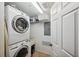 Convenient laundry room features a stacked washer and dryer, plus shelving and storage at 1200 Country Club Dr # 5506, Largo, FL 33771