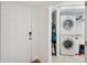Hallway view into the convenient laundry room with a washer, dryer, and storage space at 1200 Country Club Dr # 5506, Largo, FL 33771