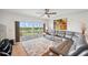 Bright living room features a large window with golf course views and a comfortable gray leather sectional at 1200 Country Club Dr # 5506, Largo, FL 33771