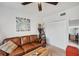 Inviting living room features a brown leather sofa and decorative accents at 1200 Country Club Dr # 5506, Largo, FL 33771