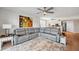 Comfortable living room featuring a cozy sectional sofa, elegant decor, and seamless access to the kitchen and dining area at 1200 Country Club Dr # 5506, Largo, FL 33771