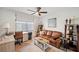Cozy living room with a brown leather couch and home office setup at 1200 Country Club Dr # 5506, Largo, FL 33771