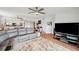 Relaxing living area with a comfortable sectional, entertainment center, and easy flow into the adjacent kitchen and dining space at 1200 Country Club Dr # 5506, Largo, FL 33771