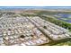 Wide overhead shot of community, highlighting homes with waterways and coastal scenery at 123 Saint Kitts Way, Apollo Beach, FL 33572