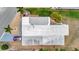 Aerial view of home, including driveway with car, landscaping and roof detailing at 123 Saint Kitts Way, Apollo Beach, FL 33572