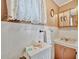 Retro bathroom with decorative mirror, towel rack, and ample counter space at 123 Saint Kitts Way, Apollo Beach, FL 33572