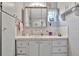 Bright bathroom with white cabinets, decorative mirror, and built in storage on the side at 123 Saint Kitts Way, Apollo Beach, FL 33572