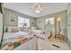 Charming bedroom featuring two twin beds with light green walls and soft natural light at 123 Saint Kitts Way, Apollo Beach, FL 33572