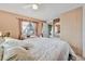 Comfortable bedroom with a ceiling fan, window with curtains and natural light at 123 Saint Kitts Way, Apollo Beach, FL 33572