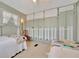 Bedroom featuring two twin beds, a white picket fence design on the wall and neutral carpeting at 123 Saint Kitts Way, Apollo Beach, FL 33572