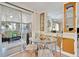The dining area has sliding glass doors leading to a sunroom, and open built-in shelving at 123 Saint Kitts Way, Apollo Beach, FL 33572