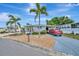 Charming single-story home featuring a well-maintained yard, beautiful landscaping, and a covered carport at 123 Saint Kitts Way, Apollo Beach, FL 33572