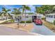 Charming mobile home with a well-maintained front yard, palm trees, and driveway parking at 123 Saint Kitts Way, Apollo Beach, FL 33572