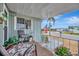 Charming front porch with seating, plants, and an American flag overlooking the street at 123 Saint Kitts Way, Apollo Beach, FL 33572