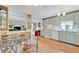 Cozy kitchen with a glass table, white appliances, and light green cabinets at 123 Saint Kitts Way, Apollo Beach, FL 33572
