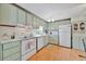 Well-lit kitchen with plenty of cabinet space, appliances and a bright laminate floor at 123 Saint Kitts Way, Apollo Beach, FL 33572