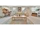 Cozy living room featuring large windows, neutral-toned furniture, and decorative accents at 123 Saint Kitts Way, Apollo Beach, FL 33572