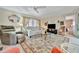 Cozy living room featuring a ceiling fan, comfortable seating arrangement, and an area rug at 123 Saint Kitts Way, Apollo Beach, FL 33572