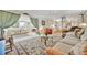 Open-concept living room with a view into the kitchen, featuring couches, and area rugs at 123 Saint Kitts Way, Apollo Beach, FL 33572