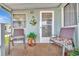 Charming covered porch featuring comfortable seating and a welcoming entrance at 123 Saint Kitts Way, Apollo Beach, FL 33572
