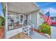 Cozy covered porch with comfortable seating, perfect for relaxing and enjoying the outdoors at 123 Saint Kitts Way, Apollo Beach, FL 33572