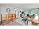 Bright sunroom with dining table, wicker furniture, and sliding glass door access to outside at 123 Saint Kitts Way, Apollo Beach, FL 33572