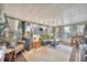 Comfortable sunroom with wicker furniture, curtains, and large windows at 123 Saint Kitts Way, Apollo Beach, FL 33572