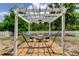 Backyard pergola with a hammock and fire pit for relaxation at 12628 White Bluff Rd, Hudson, FL 34669