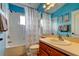 Bathroom with a tub shower, toilet and wood vanity at 12628 White Bluff Rd, Hudson, FL 34669