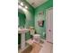Inviting bathroom with a pedestal sink, toilet, and a white tiled floor at 12628 White Bluff Rd, Hudson, FL 34669