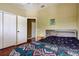 Bedroom featuring wood floors, a closet and neutral decor at 12628 White Bluff Rd, Hudson, FL 34669