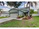 Charming two-story home with a well-manicured lawn, complemented by lush landscaping and a welcoming entrance at 12628 White Bluff Rd, Hudson, FL 34669