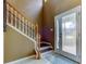 View of a foyer features a staircase with wooden banister and a glass-paneled front door at 12628 White Bluff Rd, Hudson, FL 34669