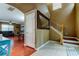 Foyer showcasing staircase with a wooden banister and a glimpse into the adjacent living and dining areas at 12628 White Bluff Rd, Hudson, FL 34669
