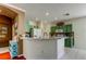 Kitchen island featuring a breakfast bar with green cabinets and white appliances at 12628 White Bluff Rd, Hudson, FL 34669