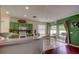 Kitchen featuring white countertops, green cabinets and stainless steel appliances at 12628 White Bluff Rd, Hudson, FL 34669