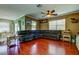 Living room featuring hardwood floors, a ceiling fan and large sectional at 12628 White Bluff Rd, Hudson, FL 34669