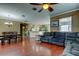 Living room with wood floors showing dining area, kitchen, and furniture at 12628 White Bluff Rd, Hudson, FL 34669