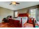 Well-lit main bedroom with hardwood floors and furnishings, including a comfortable seating area at 12628 White Bluff Rd, Hudson, FL 34669