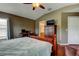 Large main bedroom with hardwood floors, work desk, and private access to the ensuite bathroom at 12628 White Bluff Rd, Hudson, FL 34669