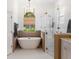 Elegant bathroom featuring a standalone tub, a walk-in shower, and modern fixtures at 12806 Castlemaine Dr, Tampa, FL 33626