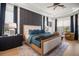 Charming bedroom with a dark accent wall, plush bedding, and decorative lighting at 12806 Castlemaine Dr, Tampa, FL 33626