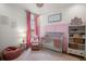 Adorable Bedroom featuring soft colors, a crib, and a comfortable beanbag chair at 12806 Castlemaine Dr, Tampa, FL 33626