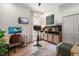 Charming office space with a desk, stationary bike, storage cabinets, and neutral tones at 12806 Castlemaine Dr, Tampa, FL 33626