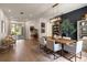 Open-concept dining area with a modern table, stylish lighting, and access to the outdoor space at 12806 Castlemaine Dr, Tampa, FL 33626