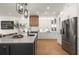 Gourmet kitchen featuring white cabinets, a large island, stainless steel appliances, and modern lighting at 12806 Castlemaine Dr, Tampa, FL 33626