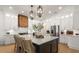 Bright kitchen featuring a center island, white cabinets, a custom range hood, and stainless steel appliances at 12806 Castlemaine Dr, Tampa, FL 33626