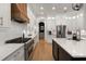 Gourmet kitchen with stainless steel appliances, white cabinets, and a large island at 12806 Castlemaine Dr, Tampa, FL 33626