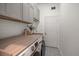 Bright laundry room features modern appliances, stylish countertop, and ample cabinet storage at 12806 Castlemaine Dr, Tampa, FL 33626