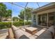 Spacious screened-in patio with comfortable wicker furniture and a scenic view of the backyard at 12806 Castlemaine Dr, Tampa, FL 33626